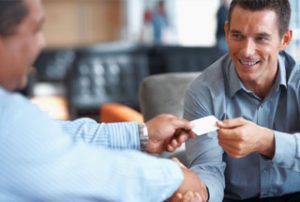 business man offering a business card to a customer